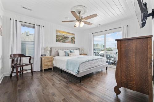 a bedroom with a bed and a ceiling fan at A Boardwalk Away in Myrtle Beach