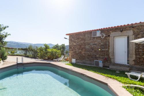 a pool in a yard next to a house at NEW! Castel de Paiva in Raiva