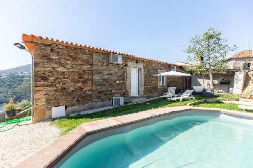 an external view of a house with a swimming pool at Casa das Dognas with Private Pool & Garden - Castelo de Paiva, by Hopstays in Castelo de Paiva