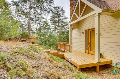 a house with a wooden porch and stairs to the door at Peeking Pines A-Frame Cabin in Bryce Resort! in Basye