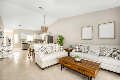a living room with two white couches and a coffee table at When in Naples!!! Pool Villa-Attached, 3 miles to the Beach in Naples