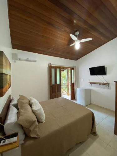 a bedroom with a bed and a ceiling fan at Pousada Oceano Atlântico in Marau