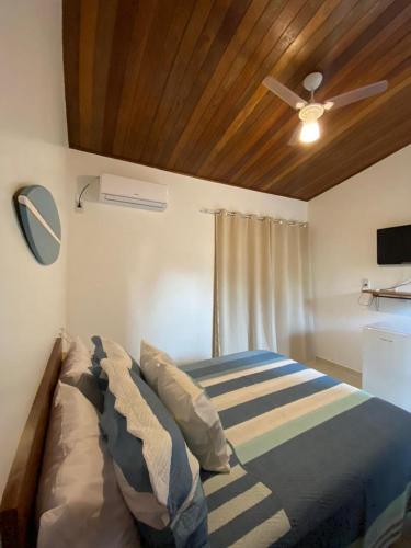 a bedroom with a bed and a ceiling fan at Pousada Oceano Atlântico in Marau