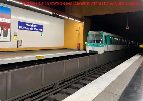 a train is pulling into a subway station at Charmant Studio climatisé Paris Expo Porte de Versailles - Dôme de Paris - proche des transports in Vanves
