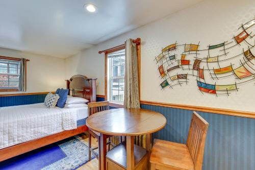 a bedroom with a bed and a table and a window at Historic Boise Studio with Courtyard, Blocks to Dtwn in Boise