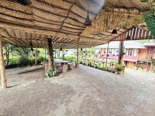 a pavilion with a picnic table under a roof at Munnar Bethel Varkis Heritage Resort in Munnar