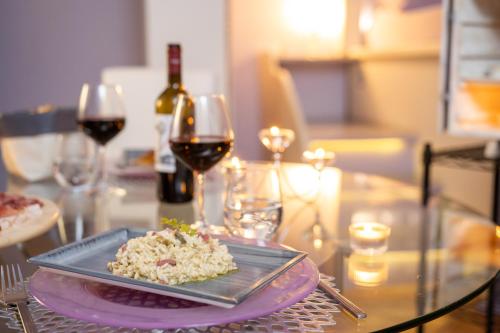 a plate of food on a table with wine glasses at Terre Dell'Amore in Grosseto