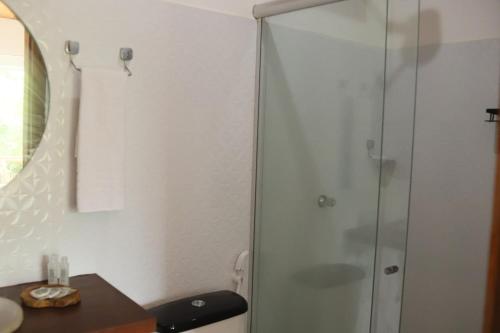 a shower with a glass door in a bathroom at Pousada Oceano Atlântico in Marau