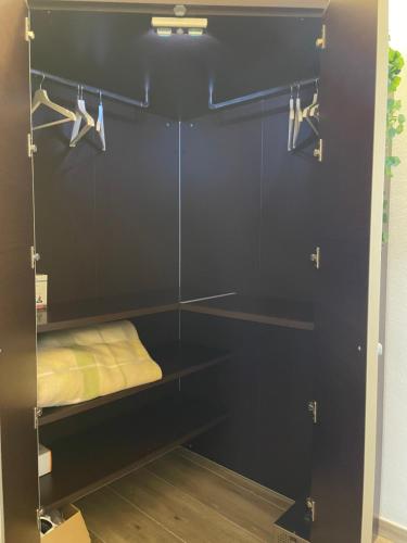 a black closet with a bed and a mirror at Casa vacanze i Giardini Iglesias in Iglesias