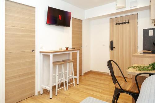 a small kitchen with a bar in a small apartment at Villa Des Bégonias - PSG in Le Pré-Saint-Gervais