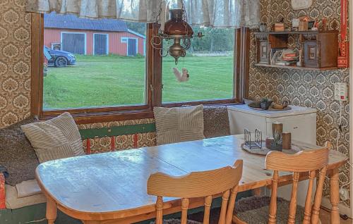 a dining room with a table and chairs and a window at Gorgeous Home In Östra Frölunda in Östra Frölunda