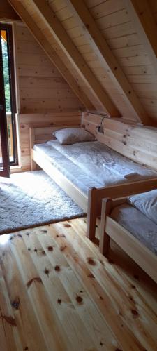 two bunk beds in a wooden attic room at Komovi-Apartment in Kolašin