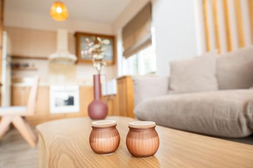 two brown vases sitting on a coffee table in a living room at Petradi Suites in Kalamata