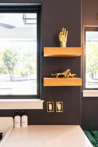 a room with shelves and a dog statue on a wall at Paradise Tiger Mansion 6BR W Pool, Weddings Events in Waxahachie