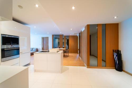 a kitchen with white appliances and a living room at Patong Kalim Unparalleled Sea View B&B Resort in Patong Beach