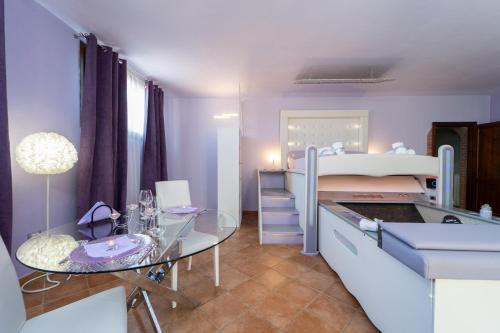 a bedroom with a bed and a glass table at Terre Dell'Amore in Grosseto