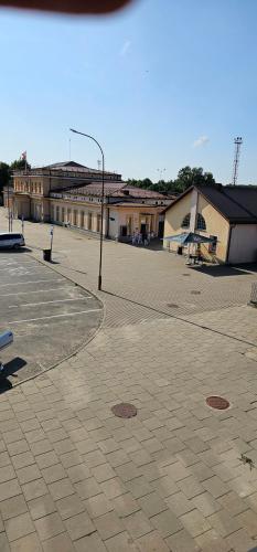 an empty parking lot with a street light and buildings at Platforma2b in Šiauliai