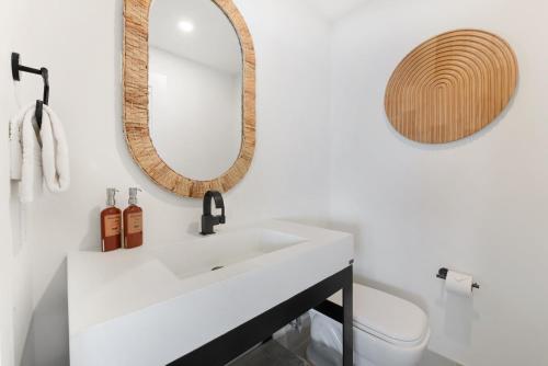 a bathroom with a white sink and a mirror at Laguna Surf Lodge by SCP Hotels in Laguna Beach