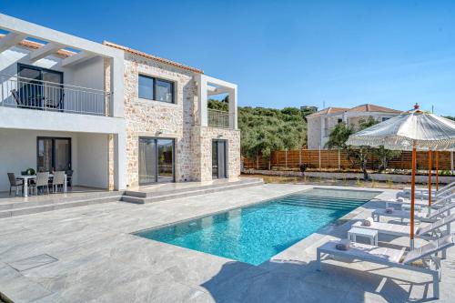 a villa with a swimming pool and a house at Edward Stone Villa in Tragaki