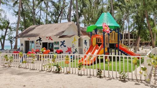 a playground in front of a building with a slide at Vista Sol Punta Cana Beach Resort & Spa - All Inclusive in Punta Cana