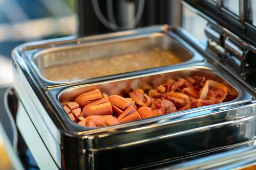 a pan full of food in an oven at Le Premier Hotel & Rooftop Bar in Hanoi