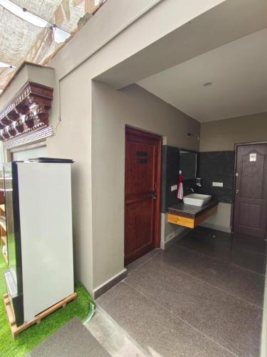 a room with a bathroom with a sink and a mirror at The Clove Ladakh in Leh