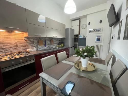 a kitchen with a table and chairs in a kitchen at La casa di Rebecca in Salerno