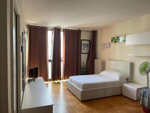a bedroom with a bed and a desk and a television at Tyche Suite Luxury in Lecce