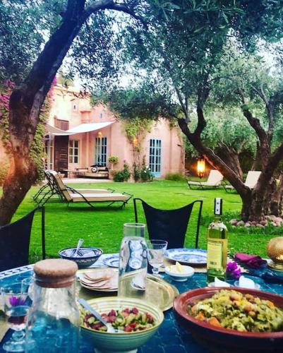 a table with plates of food on top of it at LA PORTE AU LION - Marrakech in Marrakesh