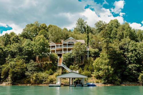 a house on the shore of a lake at Waterfront Home on Norris Lake with Boat Slip! in La Follette