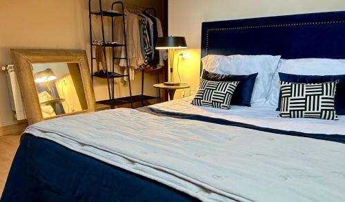 a bedroom with a large bed with two pillows at La Ventana y el Ciervu in Arenas de Cabrales