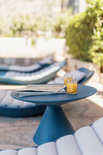 a table with two glasses of orange juice on it at Villa Blue Dream in Dobrota