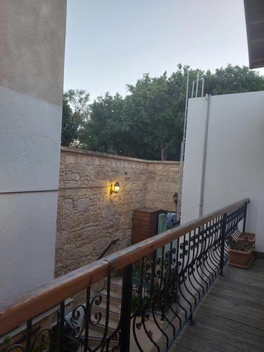 a balcony with a stone wall and a gate at Hotel Valide Hanim Konak in North Nicosia