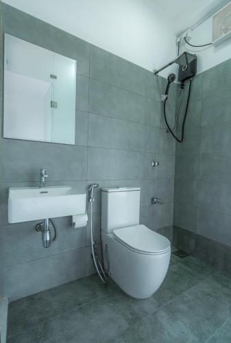 a bathroom with a toilet and a sink at Lagoon Step Airport Transit Hotel in Katunayake