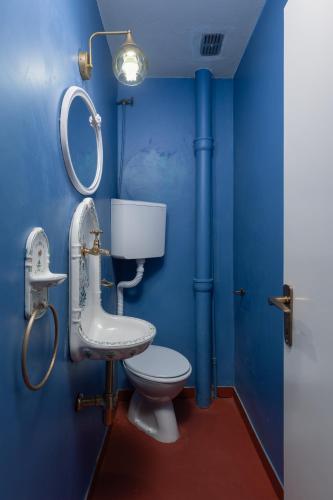 a blue bathroom with a toilet and a sink at Villa Blue Dream in Dobrota