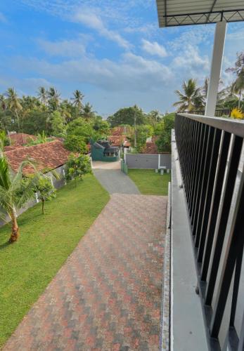 a view from the balcony of a house with a walkway at Lagoon Step Airport Transit Hotel in Katunayake