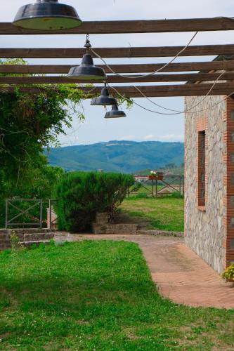 a stone building with two lights hanging from it at Casale Beatrice degli Ulivi in Orvieto