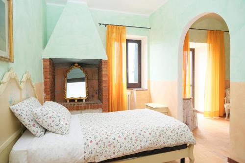 a bedroom with a white bed and a mirror at Casale Beatrice degli Ulivi in Orvieto