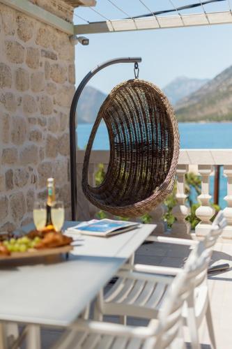 a basket hanging over a table with a plate of food at Villa Blue Dream in Dobrota
