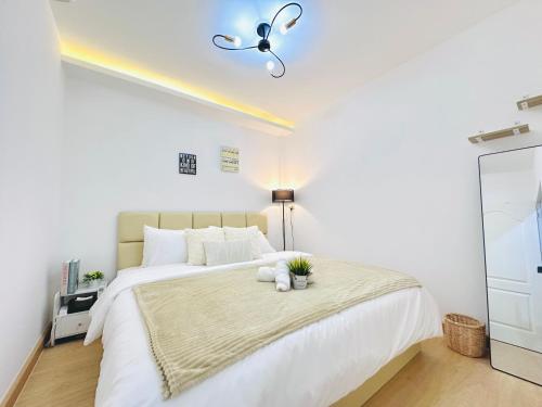a bedroom with a white bed with a teddy bear on it at White House31 EntireHouse & Rooftop DMK Airport & BTS BKK in Ban Sai Mai