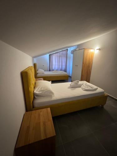 a small room with a bed and a table at Inheritor Resort in Lezhë