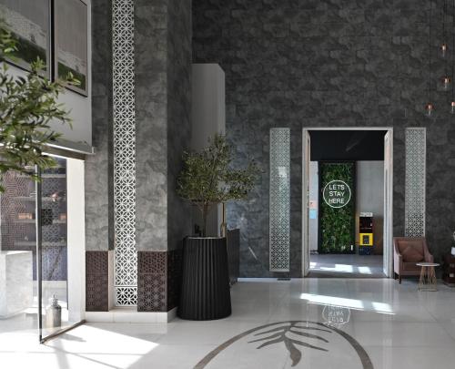 a lobby with a door with a chair and a plant at Ayan Hotel in Riyadh