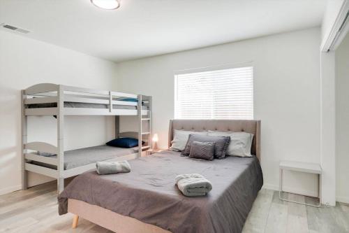 a bedroom with a bunk bed and a ladder at Oasis Haven 5BR w Pool BBQ Gourmet Kitchen in Grand Prairie