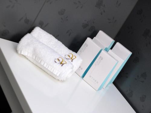 a white table with three books and a towel at Vila Mila in Bled