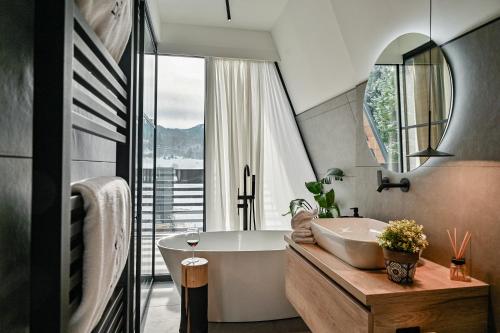 a bathroom with a tub and a large window at Villa Dia Sunger in Sunger