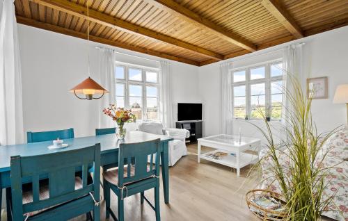 a living room with a blue table and chairs at Two-Bedroom Holiday Home In Ringkobing in Ringkøbing
