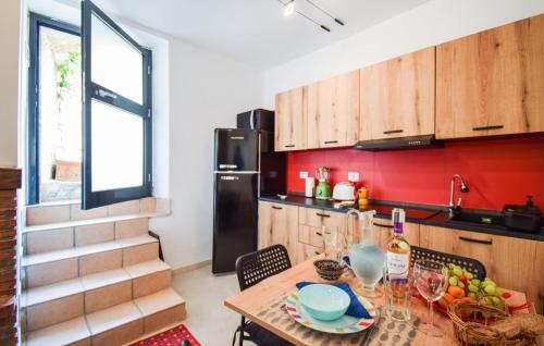 a kitchen with a wooden table with wine glasses at Beautiful Apartment In Filignano in Filignano