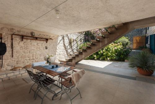 a patio with a table and chairs and a staircase at Villa Blue Dream in Dobrota