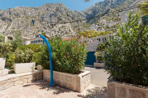a view of a building with mountains in the background at Villa Blue Dream in Dobrota