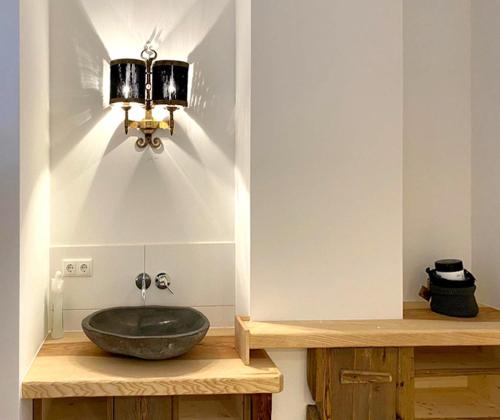 a bathroom with a bowl sink on a wooden counter at Dachstein 7 in Gosau